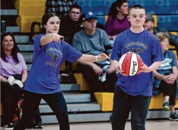  ?? Arnold Gold/Hearst Connecticu­t Media ?? Leah Brustman, left, of North Branford assists Austin Gwiazda during a CIAC unified basketball tournament at East Haven High on March 11.