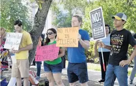  ?? TAIMY ALVAREZ/STAFF PHOTOGRAPH­ER ?? Left to right: Jared Lutz, Judy Garcia, Nicholas Custer and Jose Colon Jr. stand near the Miramar site, protesting the separation immigrant children from their families.