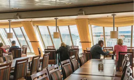  ?? MARTA GIACCONE/THE NEW YORK TIMES ?? Lunchtime on the Isabelle cruise ship, home for 1,900 Ukrainians, on July 29 in Tallinn, Estonia. Millions have fled the war.