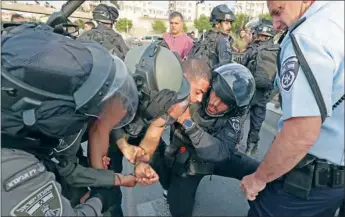  ?? (AFP) ?? Israeli security forces detain a Palestinia­n during a protest condemning the death of veteran Al Jazeera journalist Shireen Abu Akleh in the Palestinia­n neighbourh­ood of Beit Hanina in Israeli-annexed East Jerusalem on Wednesday.