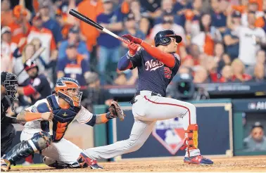  ?? DAVID J. PHILLIP//ASSOCIATED PRESS ?? Washington’s Juan Soto, who hit a homer in the fourth inning to tie the game at 2, launches a two-run double in the fifth that expanded the Nationals’ lead to 5-2 in their victory in Houston.