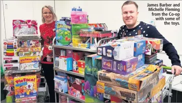  ??  ?? James Barber and Michelle Fleming from the Co-op with some of the toys.