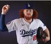  ?? CHRISTIAN PETERSEN — GETTY IMAGES ?? The Dodgers’ Dustin May is playing catch and hopes to start throwing off a mound in late April.