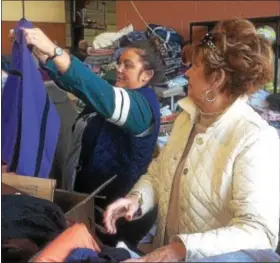  ?? PETE BANNAN – DIGITAL FIRST MEDIA ?? Barclay Friends senior home nurse Keri Foreman, left, looks for warm clothing for 100-year-old Helen Carey. Next to Foreman is Peg Hoffman of Exton, who is Carey’s daughter. “My mom is okay,” she said. “Keri, and the staff at Barclay’s is so wonderful....