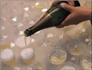  ?? PHOTO BY MATT MCCLAIN — WASHINGTON POST ?? Champagne poured at an office reception; the author’s husband often still has a single drink at business functions.