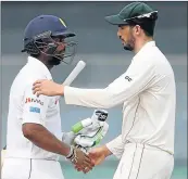  ?? Picture: AFP ?? HAND IT TO HIM: Sri Lanka’s Asela Gunaratne shakes hands with Zimbabwe captain Graeme Cremer