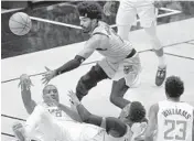  ?? MICHAEL LAUGHLIN/SUN SENTINEL ?? The Los Angeles Clippers’ Serge Ibaka passes the ball out to teammate Lou Williams.