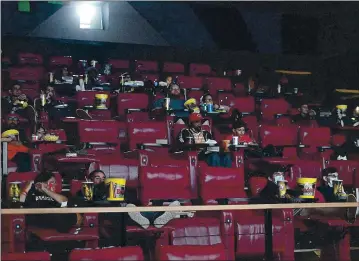  ?? JOEL ROSENBAUM — THE REPORTER ?? Moviegoers watch the opening scenes of the movie “Godzilla vs. Kong” at Brenden Theaters on Wednesday in Vacaville. After being closed for over a year due to the pandemic, the multiple-screen cinema welcomed back theatergoe­rs.