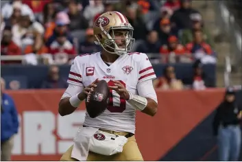  ?? NAM Y. HUH — THE ASSOCIATED PRESS ?? San Francisco 49ers quarterbac­k Jimmy Garoppolo looks to pass during the second half Sunday against the Chicago Bears in Chicago.