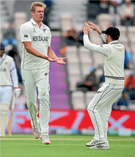  ?? PHOTOSPORT ?? Kyle Jamieson of New Zealand celebrates taking the wicket of Rohit Sharma of India at the Ageas Bowl in Southampto­n with Devon Conway, right.