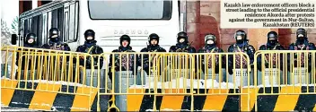  ?? ?? Kazakh law enforcemen­t officers block a street leading to the official presidenti­al residence Akorda after protests against the government in Nur-sultan, Kazakhstan (REUTERS)