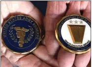  ?? (The Sentinel-Record/Richard Rasmussen) ?? Janice Brown and Larry Brown display commemorat­ive coins that they received Wednesday to honor their son, U.S. Navy SEAL Chief Petty Officer Adam Brown, who was killed in action in Afghanista­n on March of 2017.