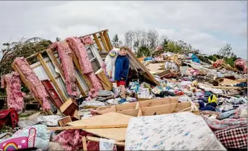  ?? Nic Antaya / New York Times ?? Harold Pate, 11, on Saturday stands in what remains of the home of his mother, Jasmine Vandenbroo­k, in Gaylord, Mich. A tornado that killed at least two people and injured dozens of others on Friday in northern Michigan demolished a mobile home park.