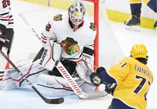  ?? MARK ZALESKI/AP ?? Goaltender Alex Stalock stops Luke Evangelist­a for one of his 35 saves Thursday in the Blackhawks’ second consecutiv­e victory.