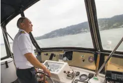  ??  ?? Capt. Tim Valka, at the helm of his charter boat on S.F. Bay, has been getting inquiries but can’t go out until Marin County says it’s safe.