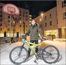  ?? CP PHOTO ?? Emad Tamo, the Yazidi boy whose photo went viral after he was freed from ISIS and eventually reunited with his mother in Winnipeg, Manitoba is photograph­ed with his new bike outside his home at Immigrant and Refugee Community Organizati­on of Manitoba recently.