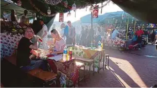  ??  ?? Bask in the energy and discover exotic food at the old medina in Marrakech.