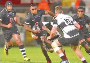  ??  ?? Vodafone Flying Fijians halfback Serupepeli Vularika takes on the Barbarians defence yesterday. Photo: Ian Muir