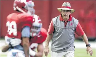  ?? Butch Dill
Associated Press ?? NICK SABAN RUNS a practice in Tuscaloosa, Ala. Saban will be trying to win his fourth national title in seven years with the Crimson Tide. Clemson has one championsh­ip.