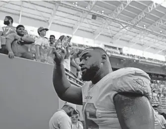  ?? JOHN MCCALL/SUN SENTINEL ?? Dolphins DT Davon Godchaux leaves the field exhausted after Sunday’s win against the Raiders because of the extra snaps he played. The Dolphins held the Raiders to 109 yards rushing despite losing three defenders Sunday.