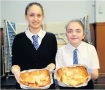  ??  ?? Happy dining Ivona Todorova, 15, and Mollie Quinn, 14, with Bulgarian dish banitska