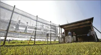  ?? TY GREENLEES PHOTOS / STAFF ?? Dan Patterson, artist in residence with the Dayton Aviation Heritage National Historical Park, had a 1904 image of the Wright brothers on Huffman Prairie printed on mesh to display at the site of the original photo.