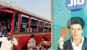  ?? Bloomberg ?? An advertisem­ent featuring Bollywood actor Shah Rukh Khan for Reliance Jio, the mobile network of Reliance Industries, is displayed at a bus stop in Mumbai, India. —