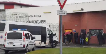  ??  ?? Prison guards block the entrance to the penitentia­ry center of Lille-Annoeullin in Annoeullin, northern France a day after a prison inmate seriously wounded two guards at the penitentia­ry center of Alencon, in Conde-sur-Sarthe, before being detained. — AFP photos