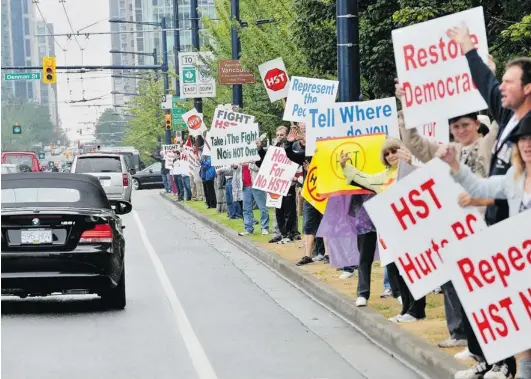  ?? IAN SMITH/ PNG FILES ?? Anti- HST protesters line Georgia Street between Denman Street and Stanley Park in 2010, the only time in the history of B. C.’ s 20- year- old referendum legislatio­n that a question has made it to the ballot. The debate continues over whether allowing...