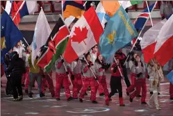  ?? Canadian Press photo ?? Canadian short-track speed skater Kim Boutin leads team Canada into the Olympic stadium carrying the Canadian flag during the closing ceremonies at the 2018 Pyeongchan­g Olympic Winter Games in Pyeongchan­g, South Korea, on Sunday.