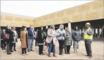  ?? PHOTO BY CESAR NEYOY/BAJO EL SOL ?? JAKE HERRINGTON (FAR RIGHT), EXECUTIVE DIRECTOR of PPEP Inc., leads guests on a tour of the constructi­on site of a new charter high school in San Luis, Ariz.