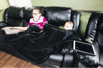  ?? GREG SOUTHAM ?? Sasha Covino, 11, watches television with her brother Ryken, 8, who has a very rare form of leukemia. The child will now undergo clinical trial in Toronto after the government agreed to pay for his stay.