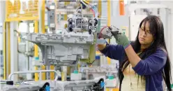  ?? — Reuters ?? A woman works in a GM auto factory in Detroit.