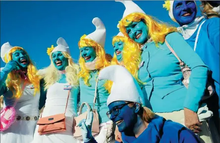  ?? REUTERS ?? Participan­ts dress as Smurfs and pose during an attempt to hold the world’s largest meeting of Smurfs in Germany on Saturday.