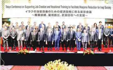  ?? — Reuters photo ?? Iraqi Foreign Minister Ibrahim al-Jaafari (sixth left, front low), Iraqi Prime Minister Haider al-Abadi (seventh left, front low), Abe (eighth left, front low) and Japan’s Foreign Minister Taro Kono (ninth left, front low) attend a family photo session...