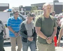  ?? THE CANADIAN PRESS FILES ?? Former Montreal, Maine and Atlantic Railway Ltd. employees Tom Harding, right, Jean Demaitre, centre, and Richard Labrie are escorted by police to appear in court in Lac-Megantic, Que., on May 13, 2014.