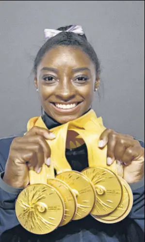  ?? AFP ?? Simone Biles poses with the five gold medals she won at the Artistic Gymnastics World Championsh­ips in Stuttgart over the past week.