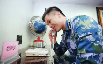  ?? PHOTOS PROVIDED TO CHINA DAILY ?? A soldier makes a greeting call to his family on a Chinese naval escort fleet in February last year. February last year.