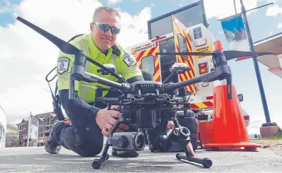  ?? Rick Bowmer, The Associated Press ?? Travis White, a member of the Utah Department of Transporta­tion’s Highway Incident Management Team, displays a drone May 20 in Park City, Utah.