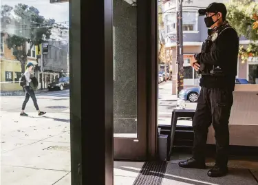  ?? Stephen Lam / The Chronicle ?? Ron Legaspi, a security guard, stands outside consumer electronic­s retailer B8ta, which reopened its Hayes Valley location in September, six months after an armed robbery forced its temporary closure.