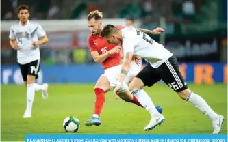  ??  ?? KLAGENFURT: Austria’s Peter Zulj (C) vies with Germany’s Niklas Sule (R) during the internatio­nal friendly footbal match Austria versus Germany in Klagenfurt, Austria, on Saturday. — AFP