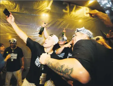  ?? Frank Franklin II / Associated Press ?? New York Yankees’ Aaron Judge, left, celebrates with teammates after they clinched a wild-card playoff birth with a 3-2 win over the Baltimore Orioles in 11 innings on Saturday in New York.