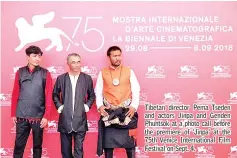  ??  ?? Tibetan director Pema Tseden and actors Jinpa and Genden Phuntsok at a photo call before the premiere of 'Jinpa' at the 75th Venice Internatio­nal Film Festival on Sept. 4.