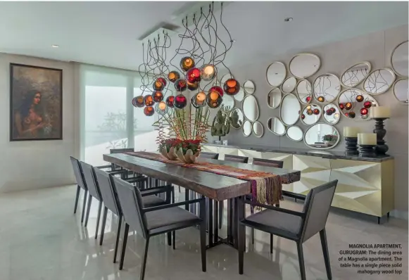  ?? ?? MAGNOLIA APARTMENT, GURUGRAM: The dining area of a Magnolia apartment. The table has a single piece solid w3o3od top