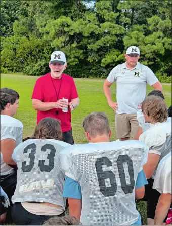  ?? PHOTO BY MIKE DIMAURO/THE DAY ?? Mike Emery, left, who enjoyed a legendary football coaching career at Montville and Fitch, remains in the game he loves after coming out of retired to be an assistant for his son Brian, right, the head coach at Manteo High School on the Outer Banks of North Carolina. “After practice, I always give the coaches a chance to talk because I’m not going to think of everything,” Brian Emery said. “Sometimes, my dad goes, ‘am I talking too much?’ I say, ‘Coach, I don’t care.’ It doesn’t make sense to cut off a great coach.”