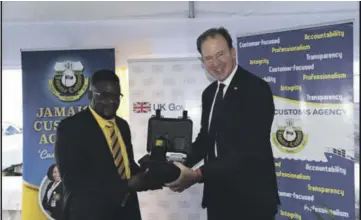  ?? ?? The Rt Hon Jesse Norman, Minister for the Americas and Overseas Territorie­s in the Foreign, Commonweal­th and Developmen­t Office, right, handing over the Buster Density Meter to Mr. Marlon Lowe, Deputy Commission­er, Border Protection at the JCA, symbolisin­g the donation of four Meters from the UK Government to the Agency.