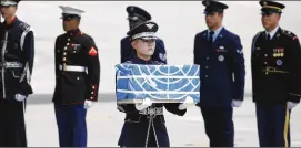  ?? KIM HONG-JI/POOL/GETTY IMAGES ?? A soldier carries a casket containing the remains of a U.S. soldier killed in the Korean War at a ceremony Friday in Pyeongtaek, South Korea.