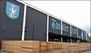  ?? Arkansas Online/BRANDON RIDDLE ?? Fassler Hall, now open on Little Rock’s East Capitol Avenue, features an 85-foot wooden bar and a fenced-in beer garden.