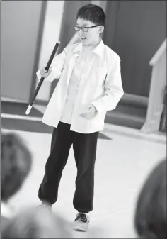  ?? Herald photo by Ian Martens ?? Steven Yang smiles as the adjudicato­r gets him to try different options for using his prop cane after performing in the 12 & under solo speech recital category this past week at St. Augustine’s Hall during the annual Kiwanis Music and Speech Arts...