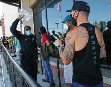  ??  ?? Bexar County Sheriff’s Deputy E. Jones hands out voter registrati­on forms Monday as lines of would-be voters formed.